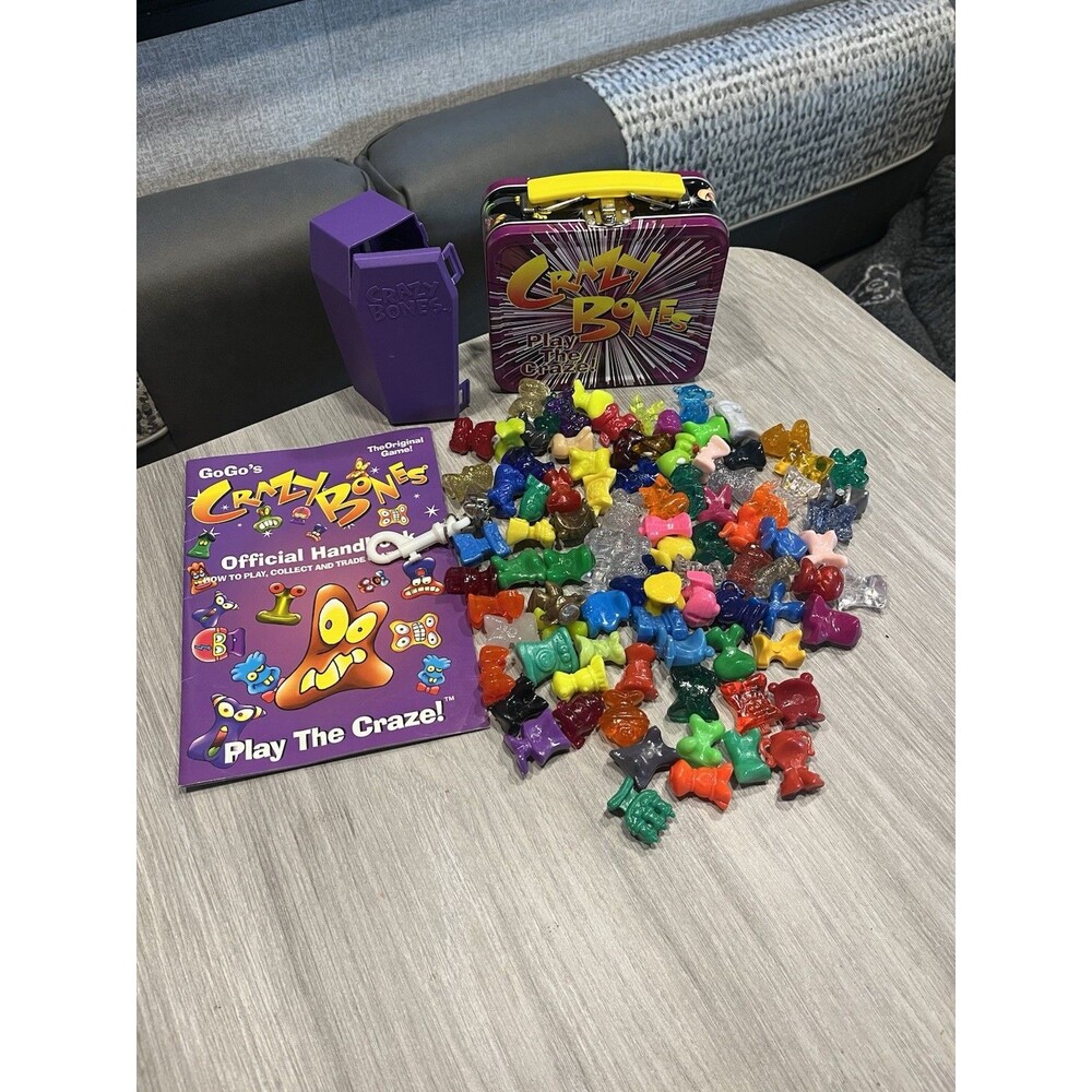 Lot Of 93 Crazy Bones, Metal Lunch Box, Handbook And Coffin